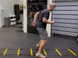 Personal trainer demonstrating agility ladder exercises