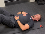Professional fitness trainer demonstrating breathing techniques