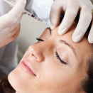 Women receiving injection of Botox in forehead