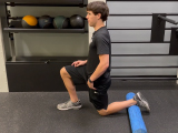 Professional fitness trainer stretching with a foam roller