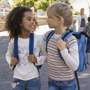 two young girls walking to school