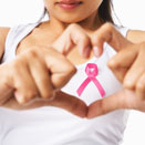 Woman wearing a pink ribbon supporting breast cancer awareness