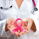 doctor holding pink breast health awareness ribbon