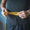 man with tape measure around waist