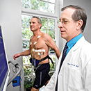 doctor with patient doing treadmill stress test