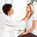 Woman having thyroid checked 