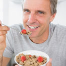 Man eating cereal with berries