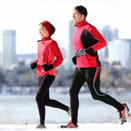 Man and woman jogging outside in winter